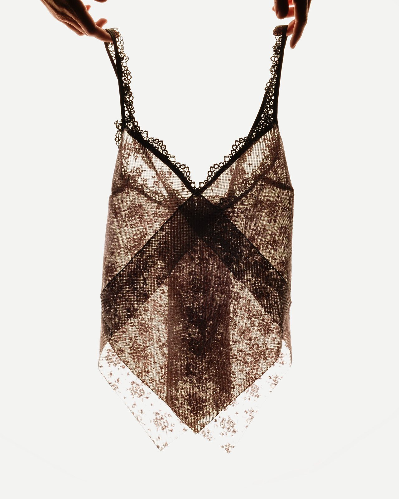 3D printed lace camisole held up against the light