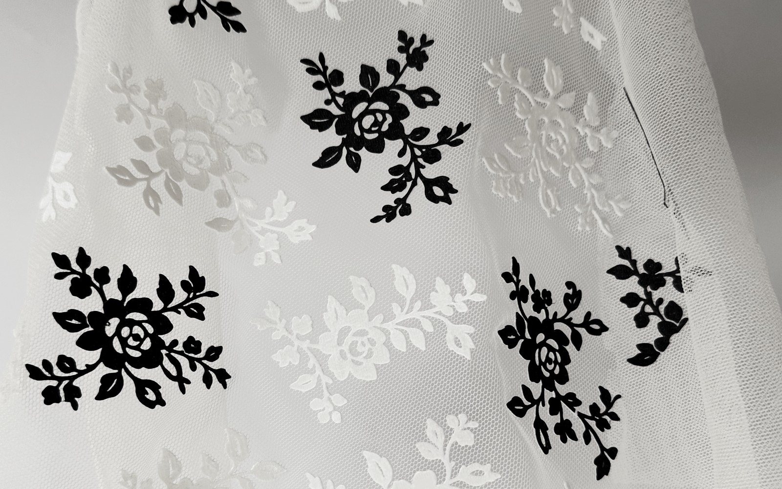 Black and white flowers 3D printed onto sheer tulle